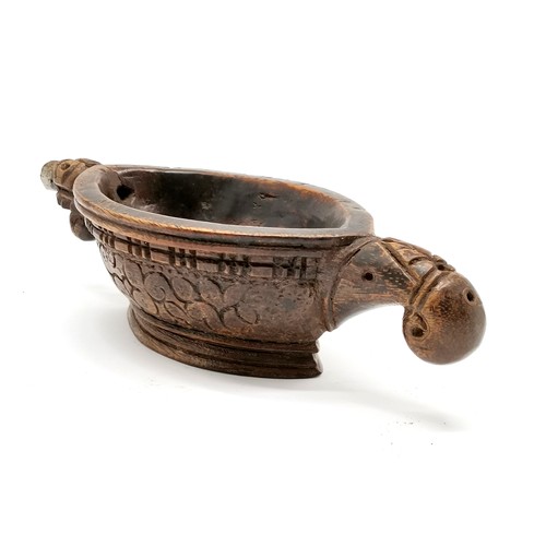 67 - Indian hand carved wooden oil lamp with metal spout - 24cm across