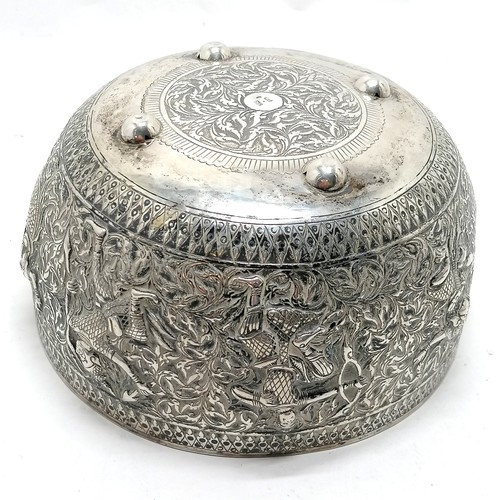 101 - Asian antique silver marked singing bowl with embossed figural detail & on 4 bun feet and marks to t... 