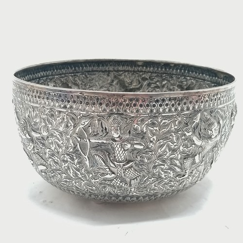 101 - Asian antique silver marked singing bowl with embossed figural detail & on 4 bun feet and marks to t... 