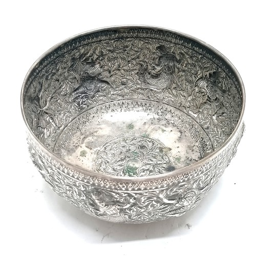 101 - Asian antique silver marked singing bowl with embossed figural detail & on 4 bun feet and marks to t... 