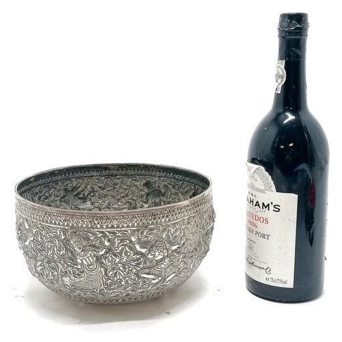 101 - Asian antique silver marked singing bowl with embossed figural detail & on 4 bun feet and marks to t... 