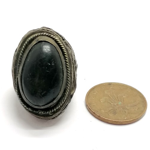 553 - Antique large eastern ring set with a nut and with bird detail to shoulders - size T