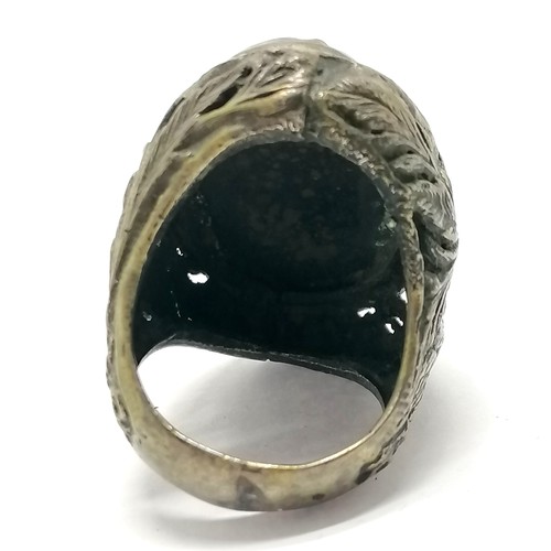 553 - Antique large eastern ring set with a nut and with bird detail to shoulders - size T