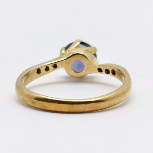 554 - 9ct hallmarked gold iolite (?) / diamond crossover ring - size L & 1.9g total weight - stone has wea... 