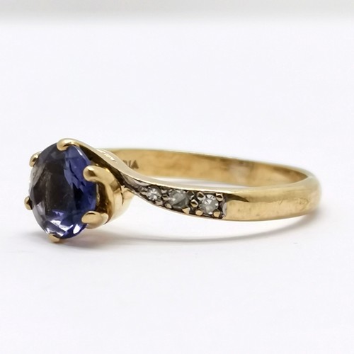 554 - 9ct hallmarked gold iolite (?) / diamond crossover ring - size L & 1.9g total weight - stone has wea... 