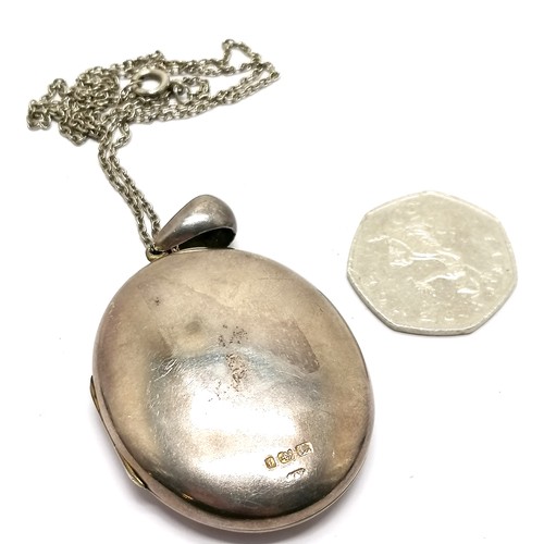 634 - Antique large silver locket pendant (6cm drop with left hand opening) on metal chain ~ 21g total wei... 