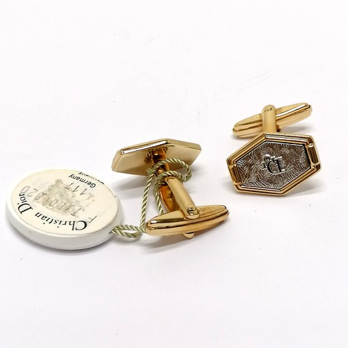 651 - Christian Dior boxed pair of gold / silver tone cufflinks with original swing tag