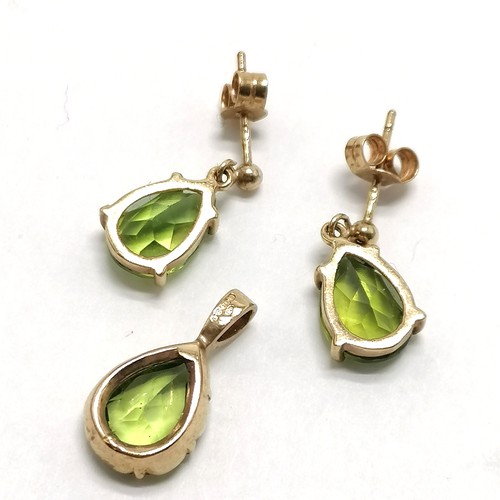 694 - 9ct hallmarked gold pair of drop earrings (1.5cm drop) with matching pendant all set with pear shape... 