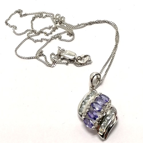 697 - 9ct hallmarked white gold tanzanite & diamond (8) & white stone set pendant on a 9ct hallmarked whit... 