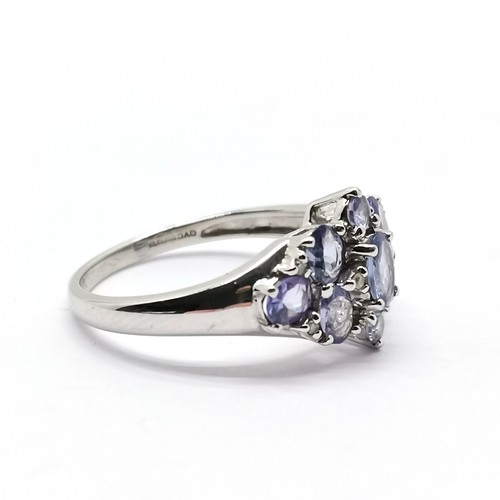 699 - 9ct hallmarked white gold tanzanite (9) & diamond (6) set ring - size O & 2.8g total weight