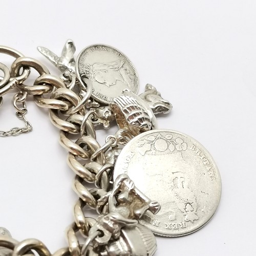 747 - Silver charm bracelet with charms inc fox head pill box, padlock & key fashioned out of QV 3d coins,... 