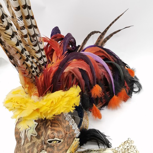 282 - 2 x Mexican Day Of The Dead masks decorated with pheasant tail feathers - skeleton 80cm high