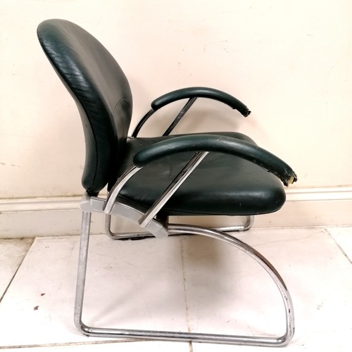 284 - Mid century pair of Eames? office chairs upholstered in green leather - 1 has both arms with chew ma... 