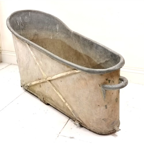 286 - Antique galvanised zinc bathtub with cross detail and handles to both ends - has a hole/dent to the ... 