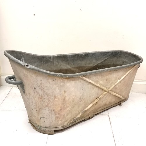 286 - Antique galvanised zinc bathtub with cross detail and handles to both ends - has a hole/dent to the ... 