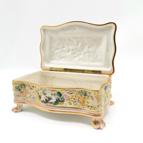 363 - Capodimonte porcelain large table box with cherubic detail terminating on 4 acanthus leaf detail fee... 