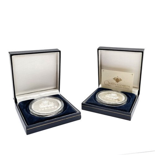 381 - 2 x cased 2010 Cunard Queen Elizabeth maiden voyage medallions