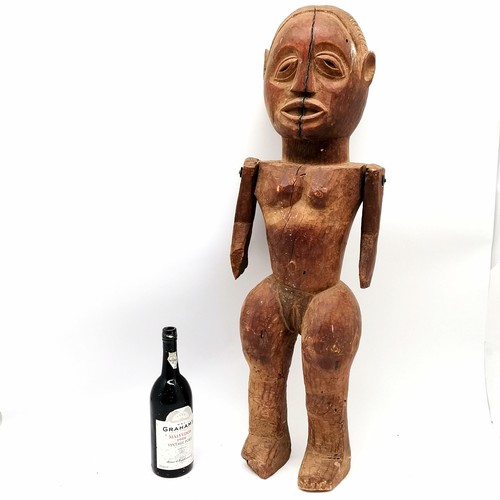 145 - African hand carved wooden ethnic fetish doll with moveable arms 85cm tall & has some losses and shr... 