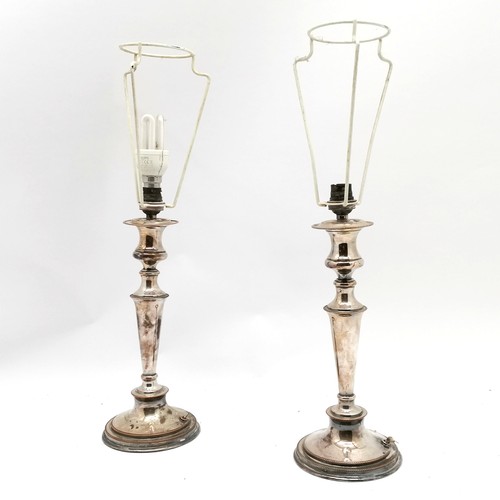 259 - Pair of silver plated table lamps in the form of candlesticks - 52cm total height & have losses to t... 