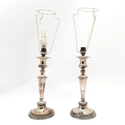 259 - Pair of silver plated table lamps in the form of candlesticks - 52cm total height & have losses to t... 