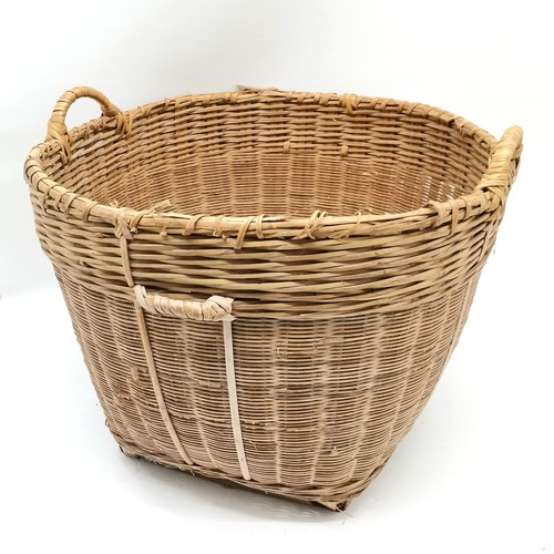 265 - Large wicker 2 handled log basket 57cm diameter x 46cm high - has slight losses