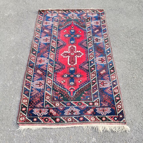 274 - Turkish dosemealti blue grounded wool rug with red medallions to the centre - 121cm x 210cm