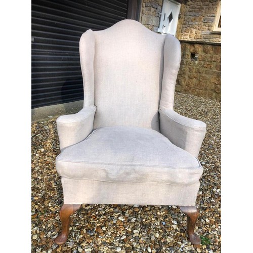 335 - Antique wing armchair upholstered in cream linen - 117cm high x 84cm wide x 80cm deep- in good used ... 