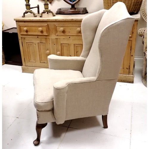 335 - Antique wing armchair upholstered in cream linen - 117cm high x 84cm wide x 80cm deep- in good used ... 