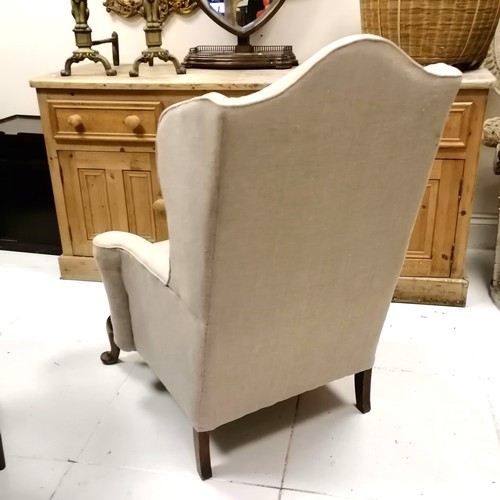 335 - Antique wing armchair upholstered in cream linen - 117cm high x 84cm wide x 80cm deep- in good used ... 