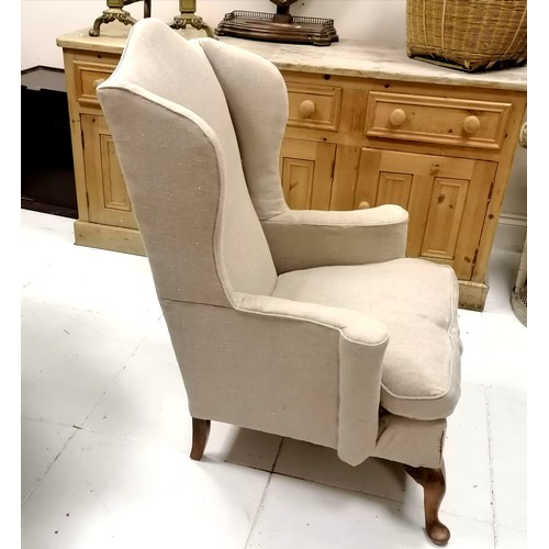 335 - Antique wing armchair upholstered in cream linen - 117cm high x 84cm wide x 80cm deep- in good used ... 