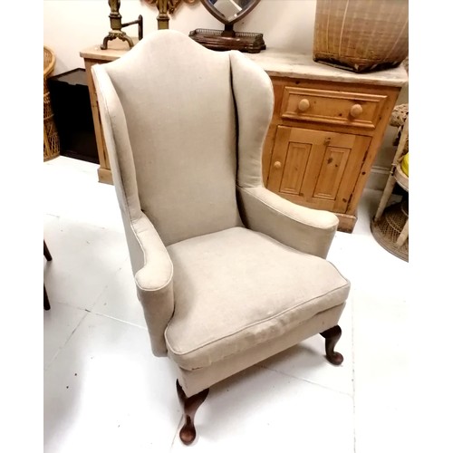 335 - Antique wing armchair upholstered in cream linen - 117cm high x 84cm wide x 80cm deep- in good used ... 