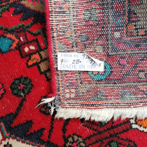 181 - Iranian red grounded wool runner with 3 central meddalions and floral detail 280cm x 100cm - has som... 