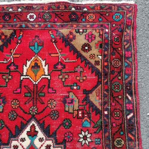 181 - Iranian red grounded wool runner with 3 central meddalions and floral detail 280cm x 100cm - has som... 