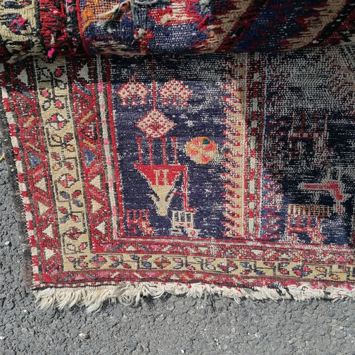 182 - Antique blue grounded wool rug with animal and figural detail 305cm x 115cm  - has obvious wear