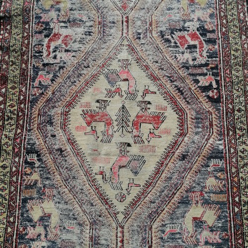 182 - Antique blue grounded wool rug with animal and figural detail 305cm x 115cm  - has obvious wear