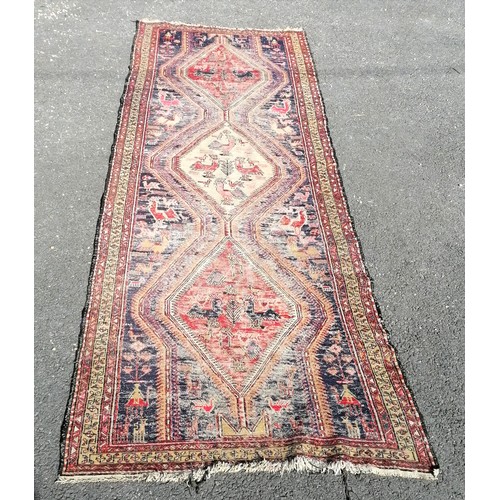 182 - Antique blue grounded wool rug with animal and figural detail 305cm x 115cm  - has obvious wear