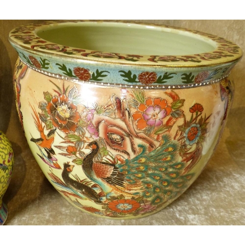 102 - A Modern Oriental Bulbous Shape Jardiniere on yellow ground having multicoloured floral, leaf and gi... 