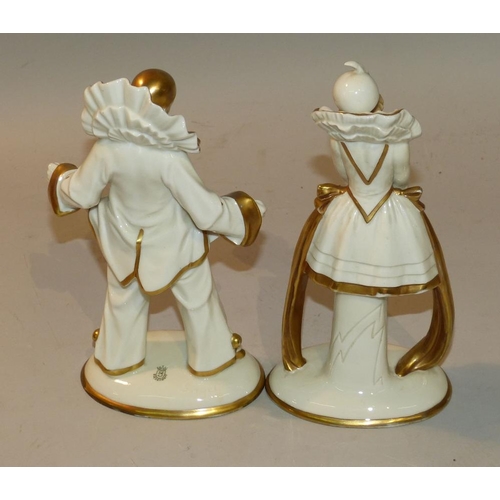 14 - A Pair Continental China Figures of Pierrot Clowns on white and gilt ground having oval bases, 23cm ... 