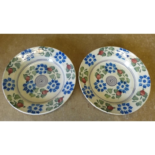 149 - A Pair of Continental Delft Plates on cream ground with blue, green, red, floral and leaf decoration... 