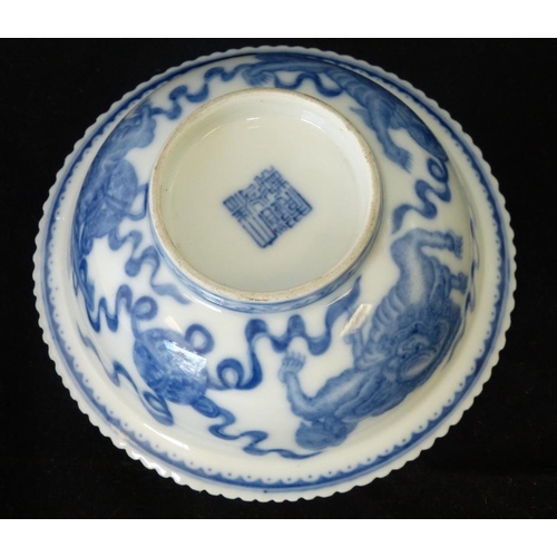 200 - An Oriental Round Lipped Bowl having crinkled rim, on blue and white ground with dragon, bat and scr... 