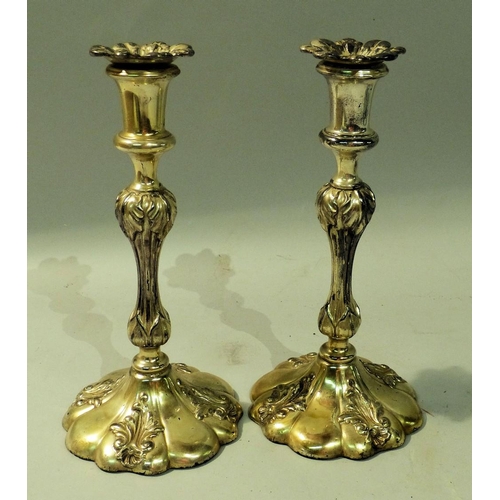 303 - A Pair of Silver Plated Candlesticks on turned stems with round scalloped shape sweeping bases, with... 