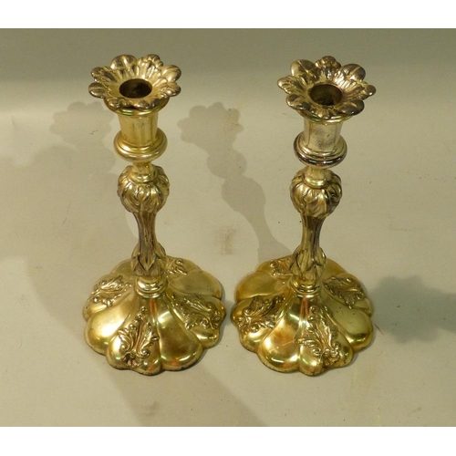 303 - A Pair of Silver Plated Candlesticks on turned stems with round scalloped shape sweeping bases, with... 