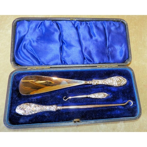 310 - A Victorian Birmingham Silver 3-Piece Cased Button Hook and Shoe Horn with embossed handles  