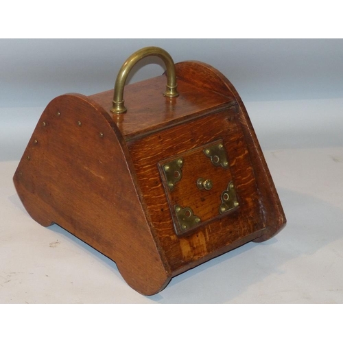 605 - An Oak Coal Box having brass centre carrying handle, studded decoration with hinged front (no shovel... 