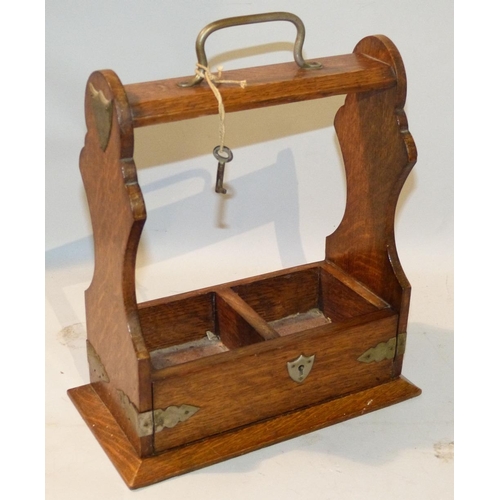 610 - An Oak 2 Bottle Tantalus (no decanters) having centre carrying handle, 26cm wide  