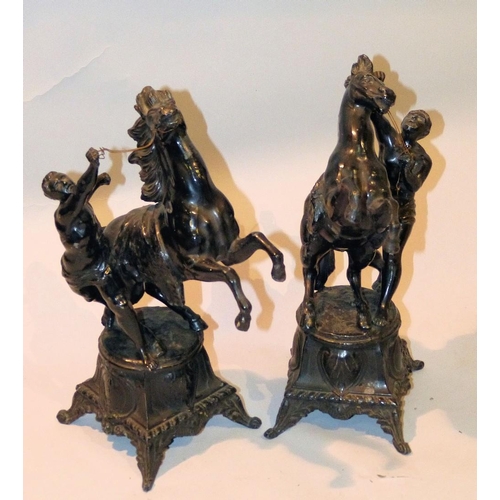 620 - A Pair of Black Painted Spelter Marley Horses on square bases with splayed feet, 34cm high  