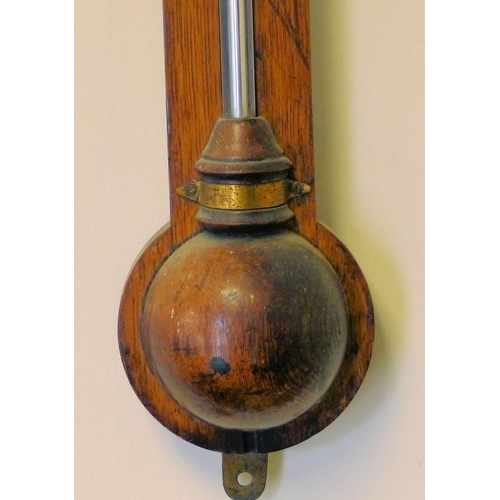 630 - A 19th Century Oak Stick Barometer with thermometer, 94cm high  