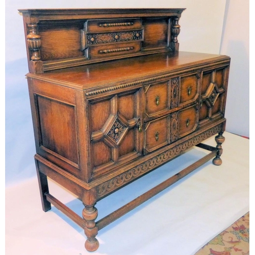 649 - A 1920's Oak Jacobean Style Sideboard having lipped back with bulbous support, 2 drawers to centre f... 