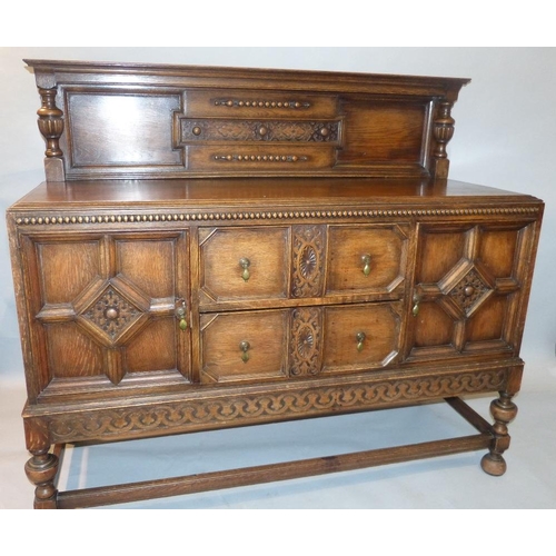 649 - A 1920's Oak Jacobean Style Sideboard having lipped back with bulbous support, 2 drawers to centre f... 