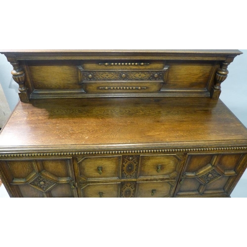 649 - A 1920's Oak Jacobean Style Sideboard having lipped back with bulbous support, 2 drawers to centre f... 